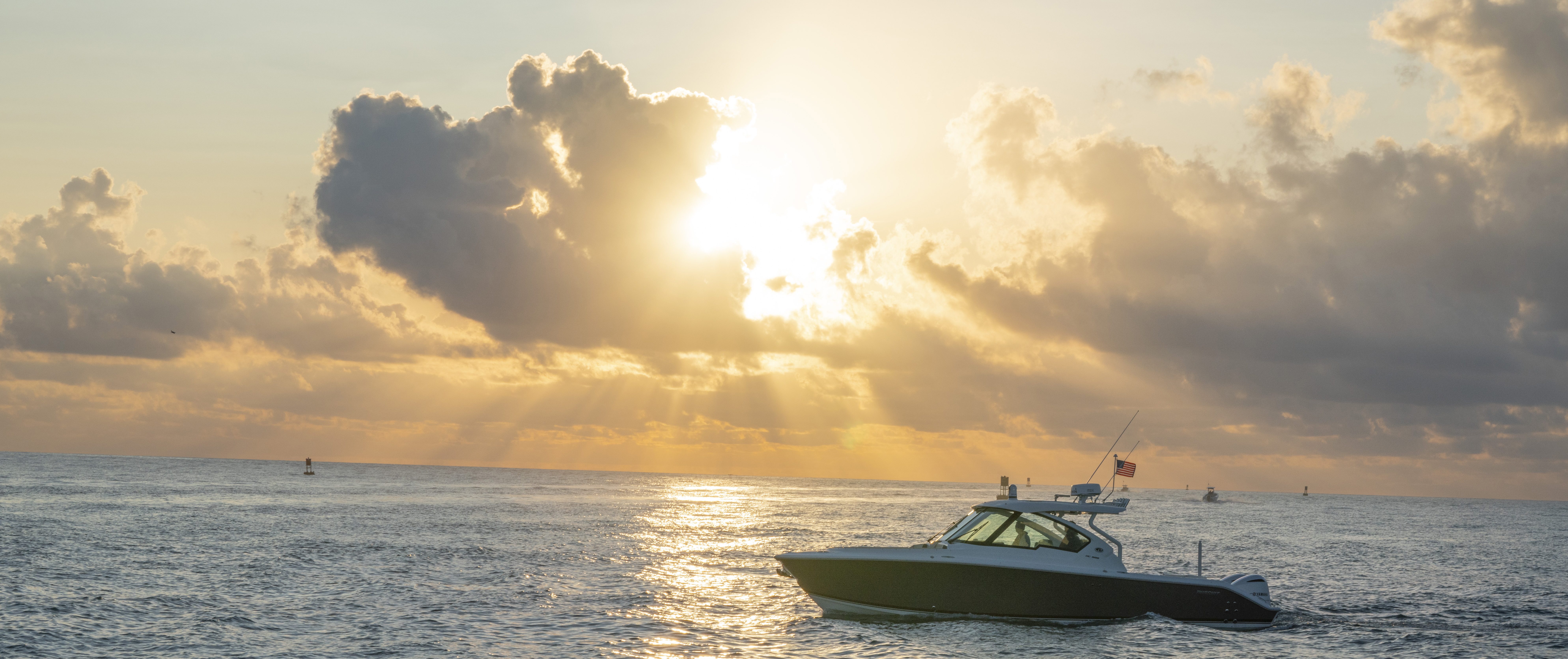 Pursuit DC326 Dual Console boat on the water at sunset